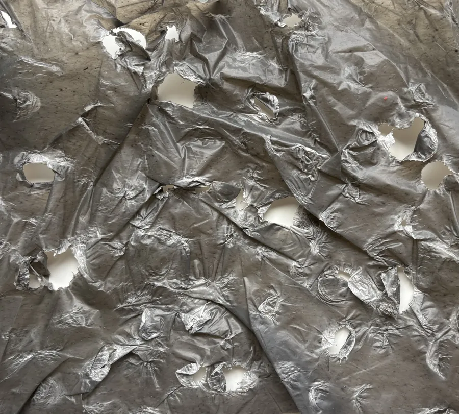 Close-up of torn, crinkled silver plastic.