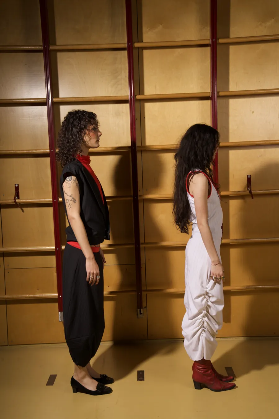 Both looks in profile, showing the ruched side of the jersey dress.