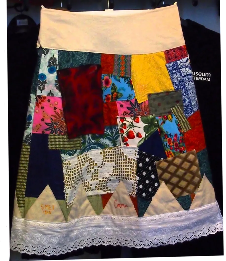 The skirt laid flat: patches in red, blue, yellow, florals and checks, with a band of triangles and a lace hem.